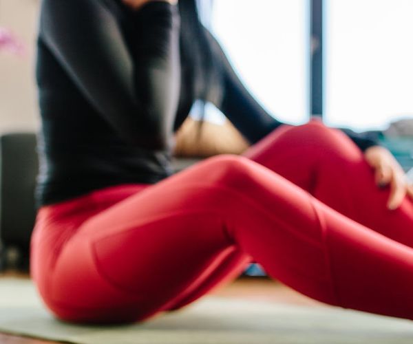 Person stretching in a bright, open space, showcasing flexibility.