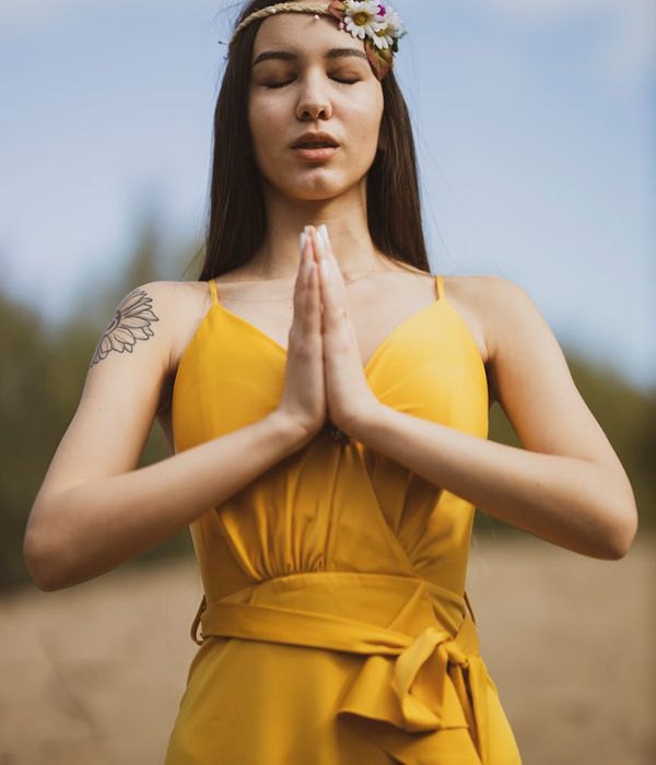 Woman in a serene yoga pose, embodying gentle energy and focus.